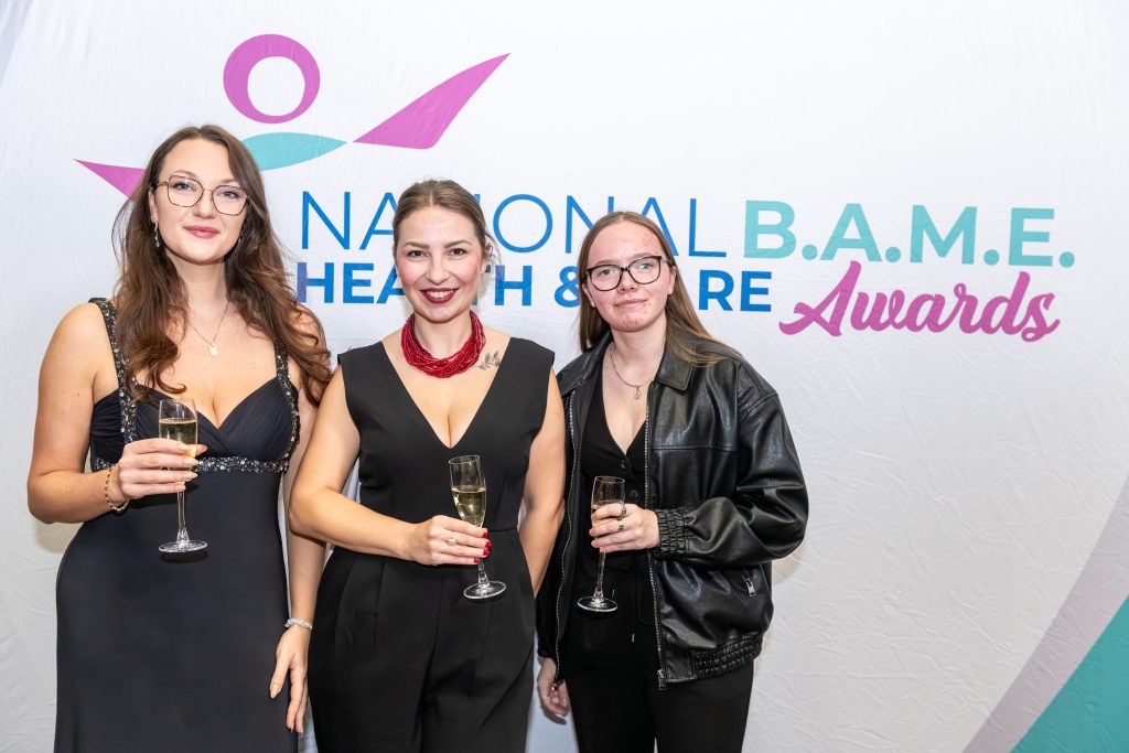 Guests posing in front of the National B.A.M.E Health and Care Awards photo wall